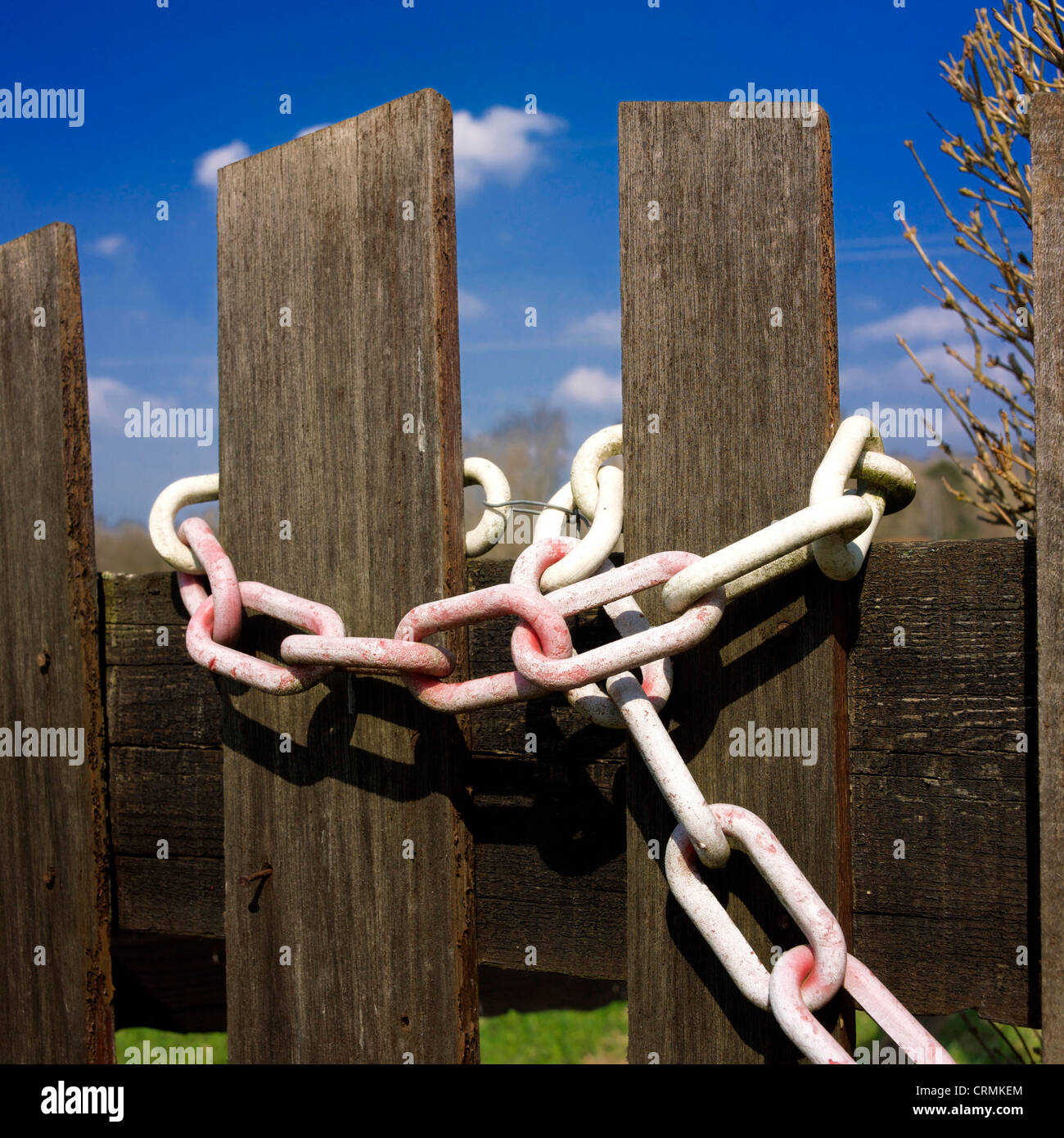 Chain around a wooden fence. Stock Photo