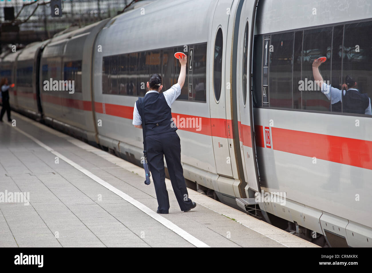 Female guards on a German Railways Intercity Express (ICE) about to depart the train from Cologne Germany Stock Photo