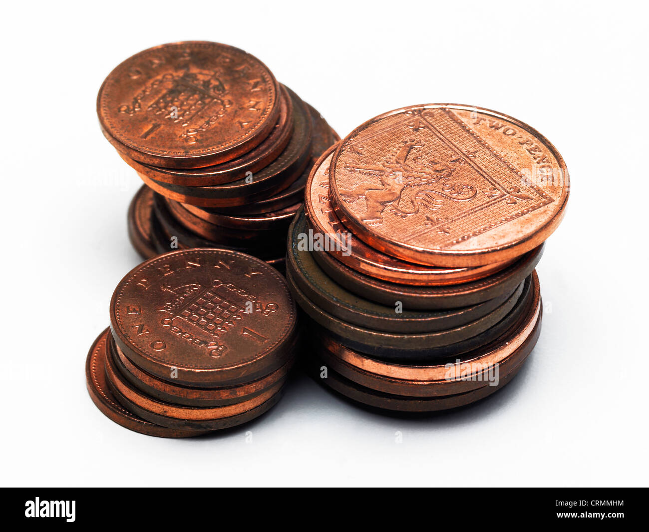 Three piles of British pennies and two pence pieces Stock Photo