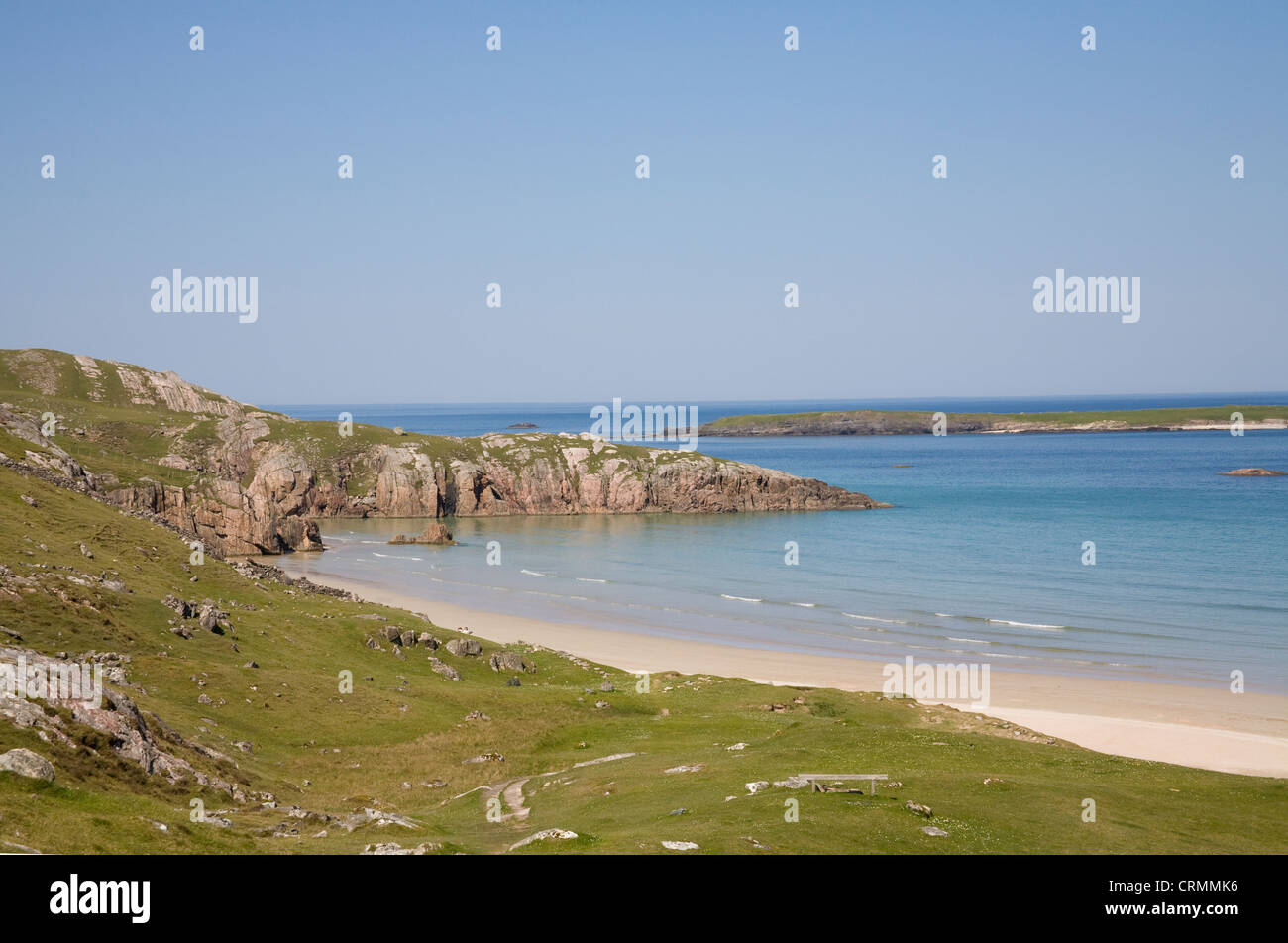 Ceannabeinne Sutherland Scotland May View across lovely sandy beach surrounded by rocky coastline Stock Photo