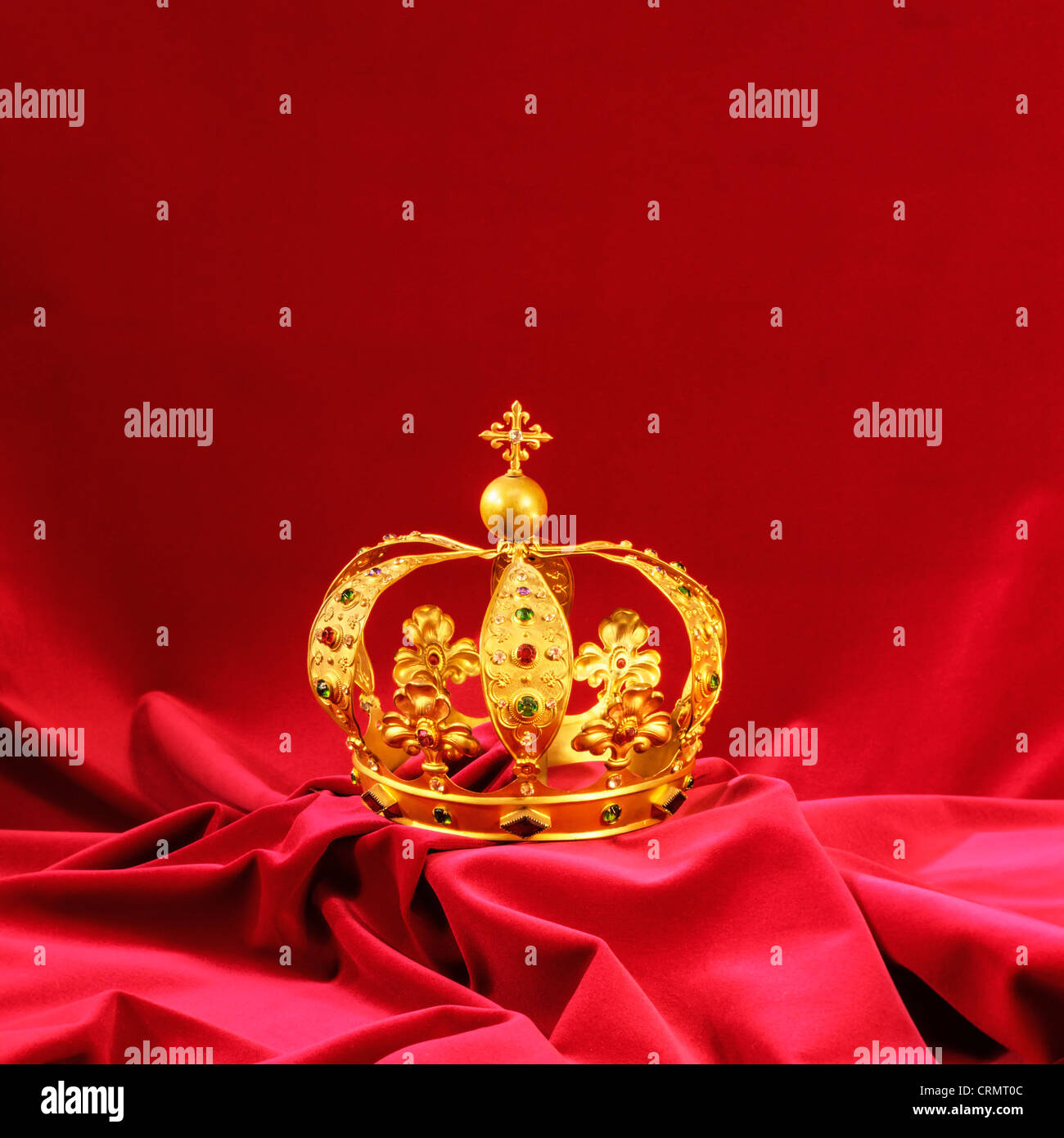 Golden crown with diamonds and jewels on garnet velvet Stock Photo