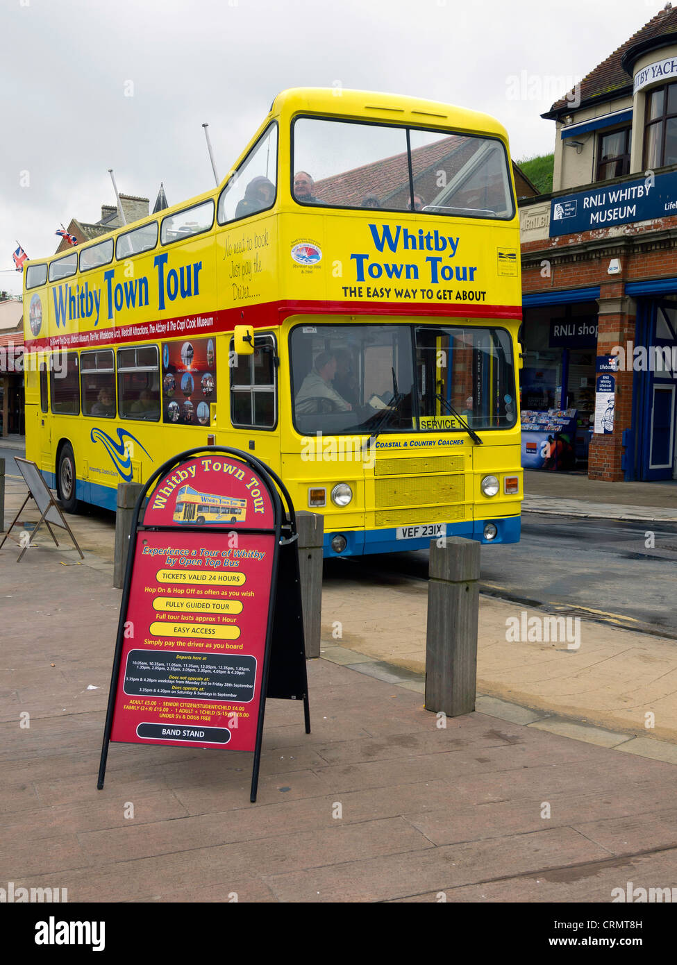 An open topped double decker local tour bus in  Whitby North Yorkshire UK almost deserted in bad weather June 2012 Stock Photo