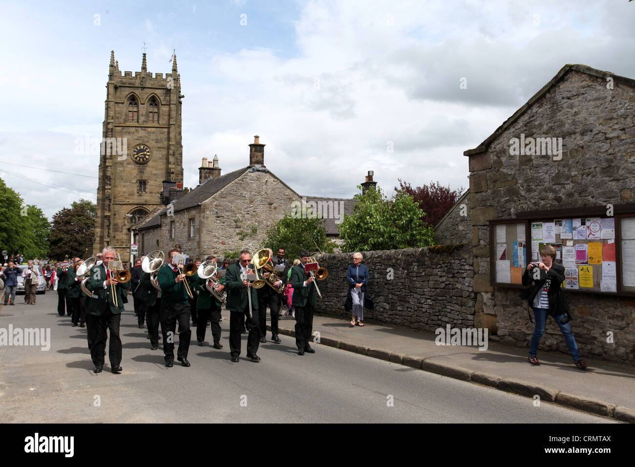 The Village Band Marching Through the Derbyshire Village of Youlgreave for the Blessing of the Well Dressings Stock Photo