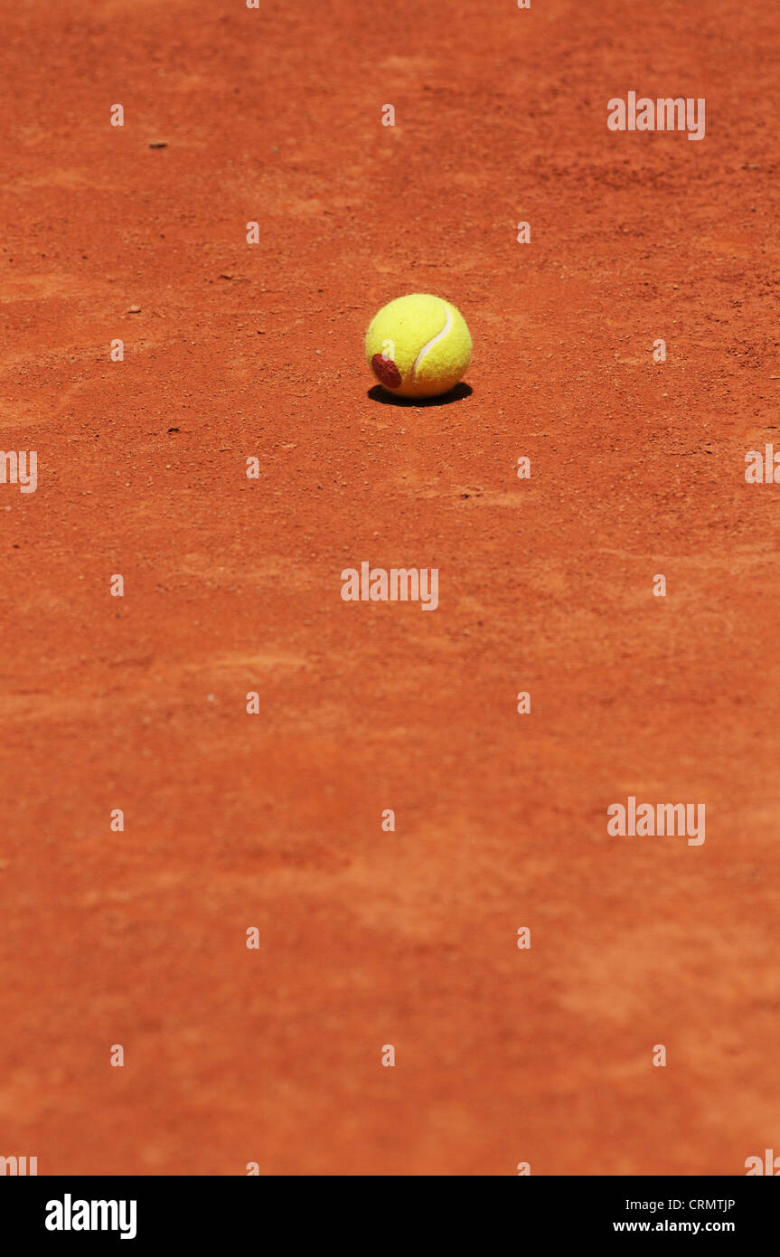 Tennis ball on the clay court. Training time. Stock Photo