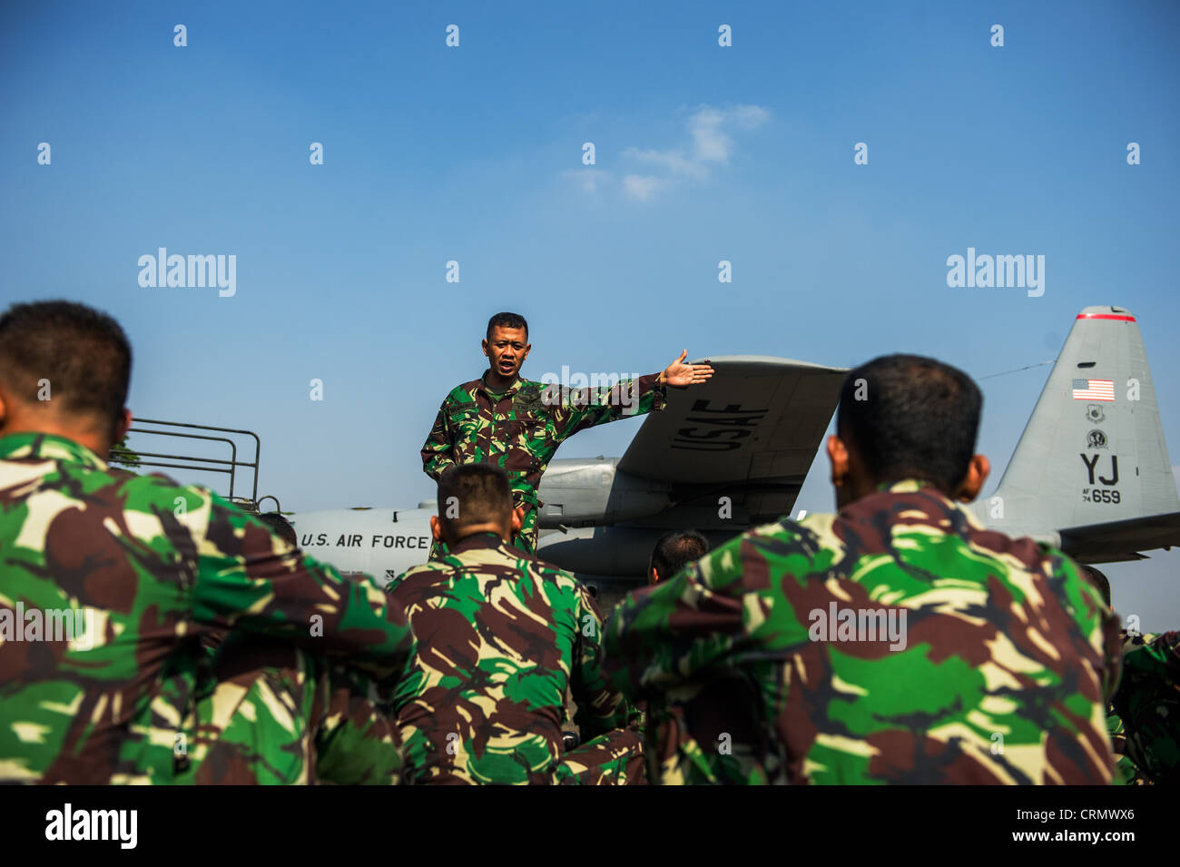 Indonesian Air Force members prepare for jump training in a U.S. Air Force C-130 June 26, 2012, at Halim Air Base, Indonesia. Exercise Cope West is a bilateral, tactical airlift exercise involving the U.S. and Indonesian Air Forces. The exercise is designed to advance interoperability between the U.S. and Indonesian Air Forces, allow for the exchange of techniques related to airlift, air-land, and airdrop delivery specific to U.S. and Indonesian aircraft, and promote regional stability. Stock Photo