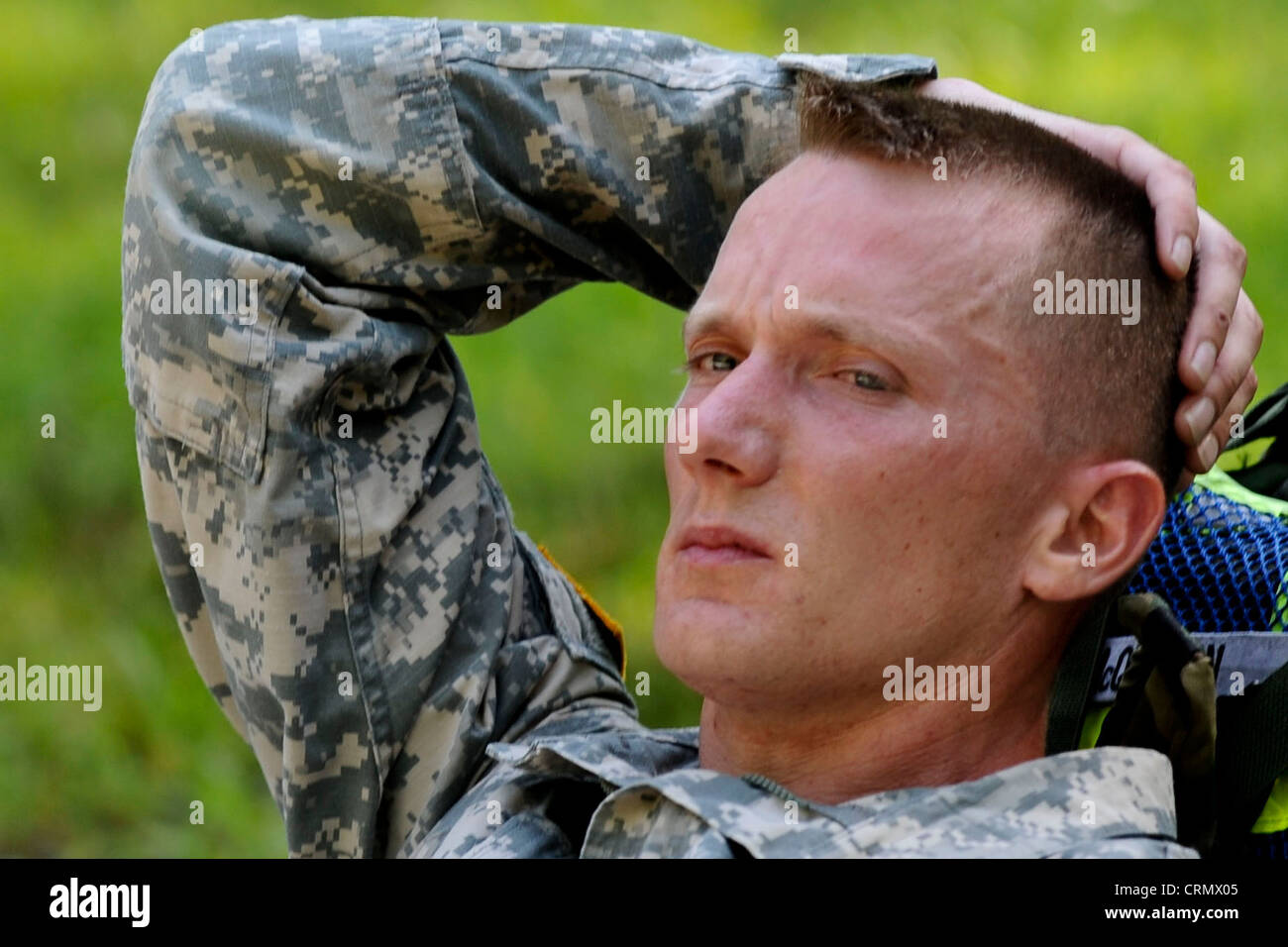 U.S. Army Sgt. 1st Class Adam McQuiston, Fort Leonard Wood, Mo., drill instructor, relaxes for a moment after completing a ruck march from the land navigation course to the confidence course, June 27, 2012, at part of the annual Drill Sergeant of the Year competition, hosted by Initial Military Training, U.S. Army Training and Doctrine Command at Fort Eustis, Va. During the week long competition drill sergeants competed in a variety of events designed to challenge them both physically and mentally. Stock Photo
