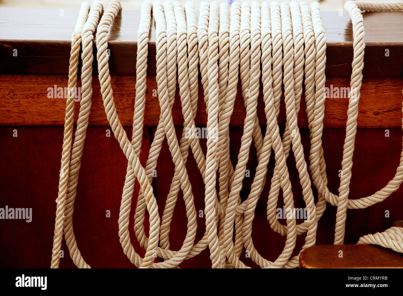 Marine ropes in a row on vintage wooden boat board Stock Photo