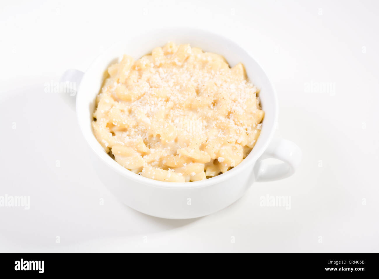 Vegan Macaroni and "Cheese" made with soy milk and nutritional yeast topped with bread crumbs on white Stock Photo