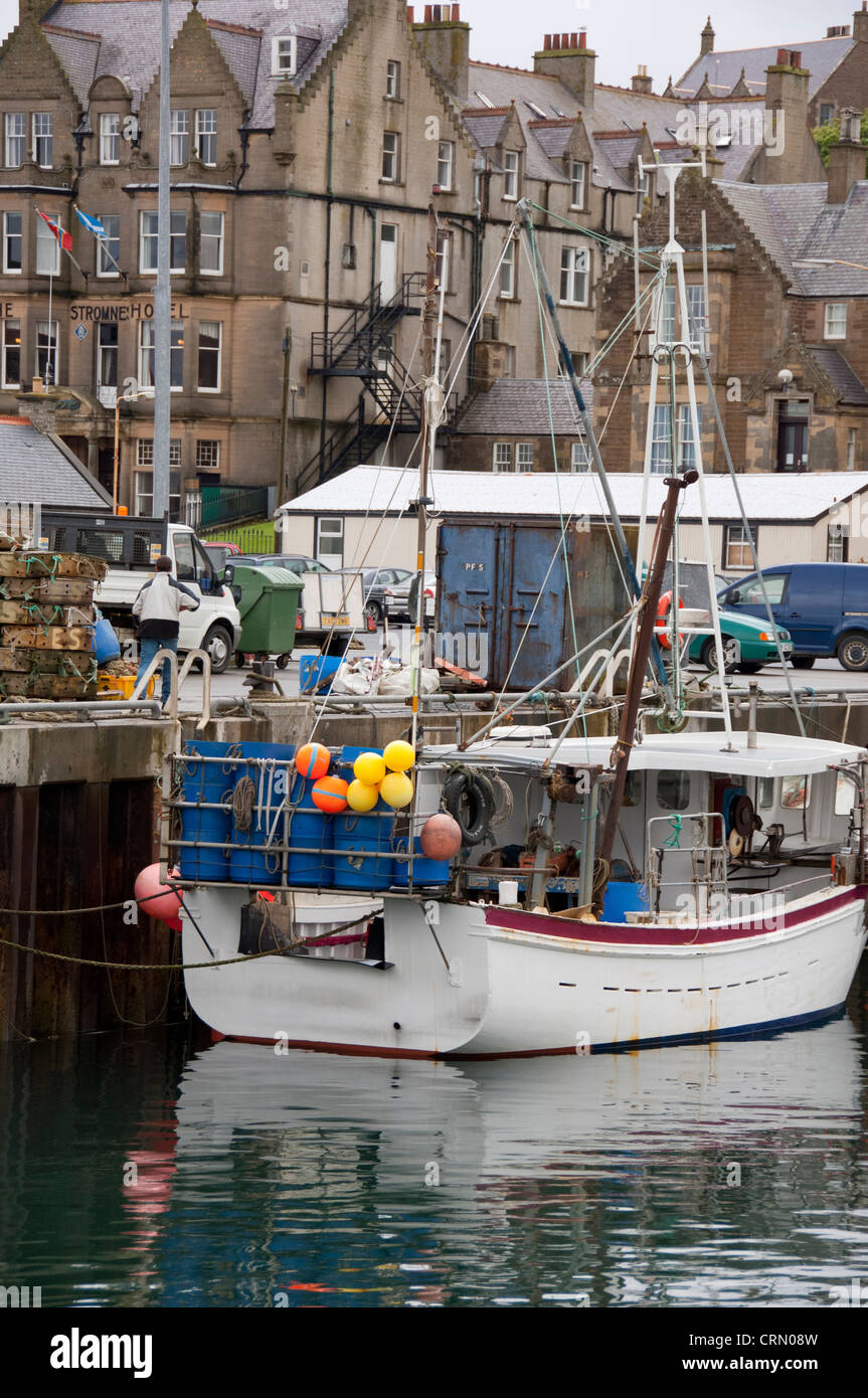 Scotland, Orkney Islands, Mainland. Capital city of Stromness. Fishing boat at downtown dock. Stock Photo