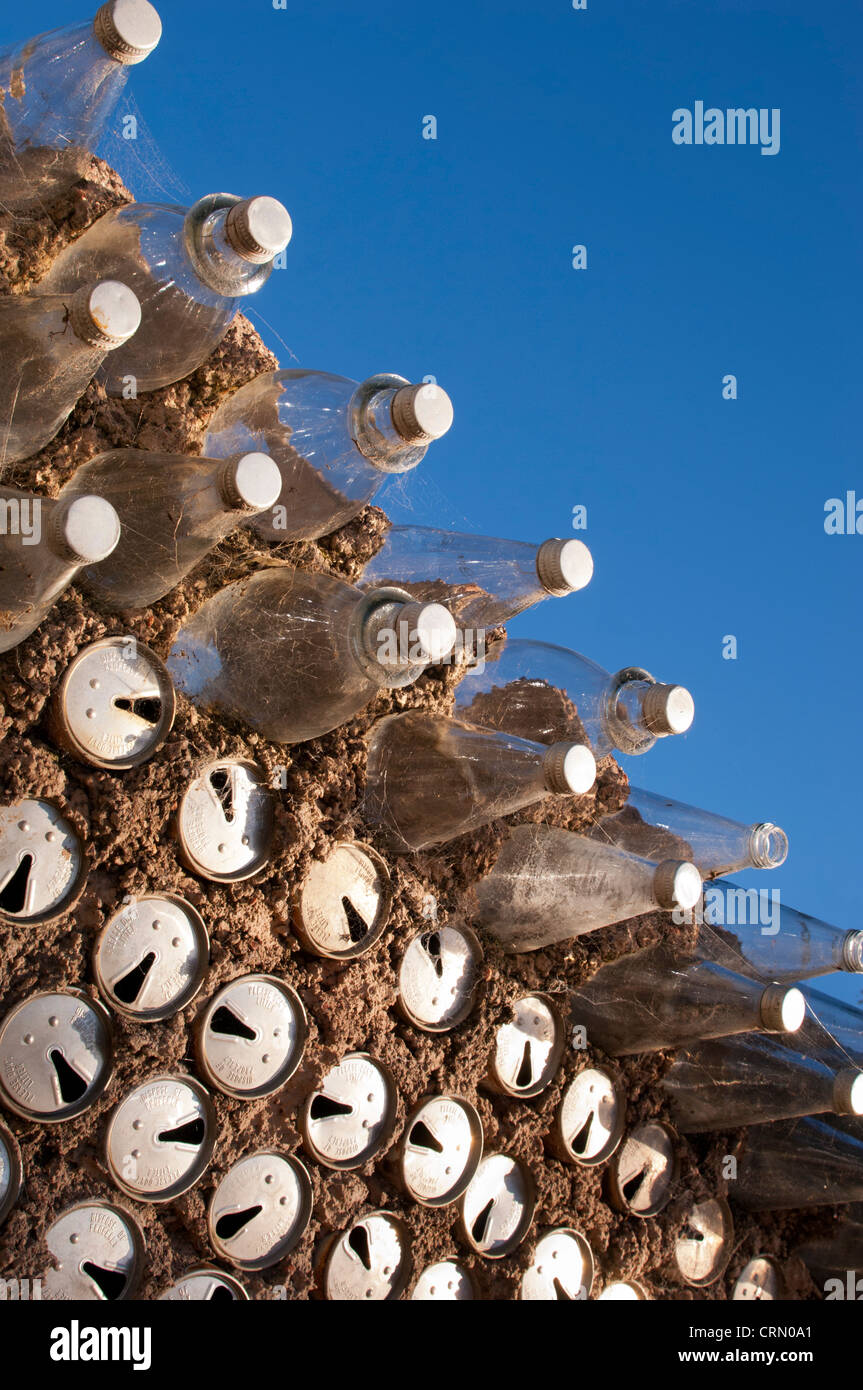 Old beer cans and glass bottles used to build a wall as a background texture Stock Photo