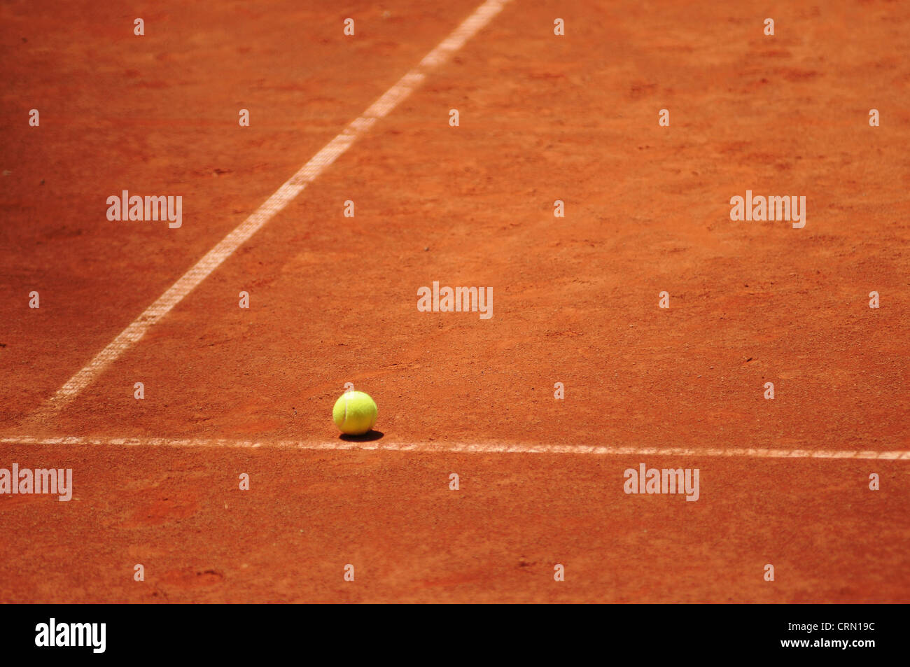 Tennis ball on the clay court. Stock Photo