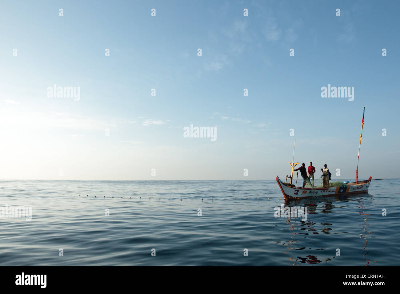 Fishermen pull in their nets while fishing off the coast near Cape Coast, Central Region, Ghana. Stock Photo