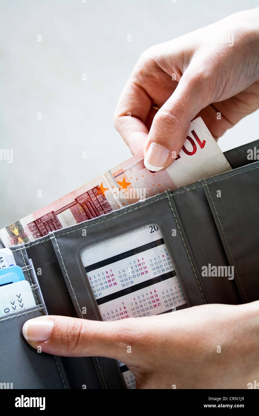 Female hands taking out money from the wallet Stock Photo