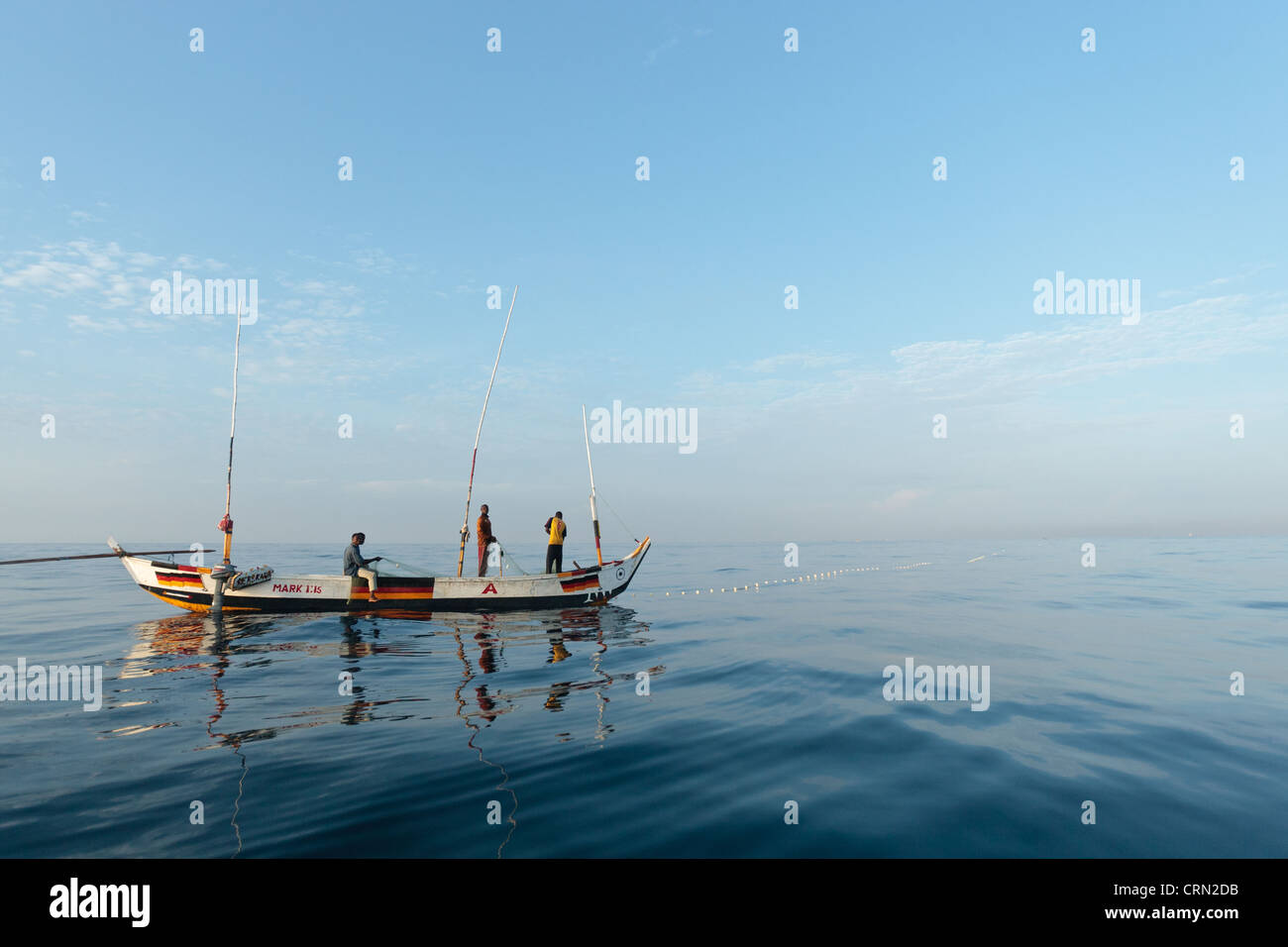 Fishermen pull in their nets while fishing off the coast near Cape Coast, Central Region, Ghana. Stock Photo