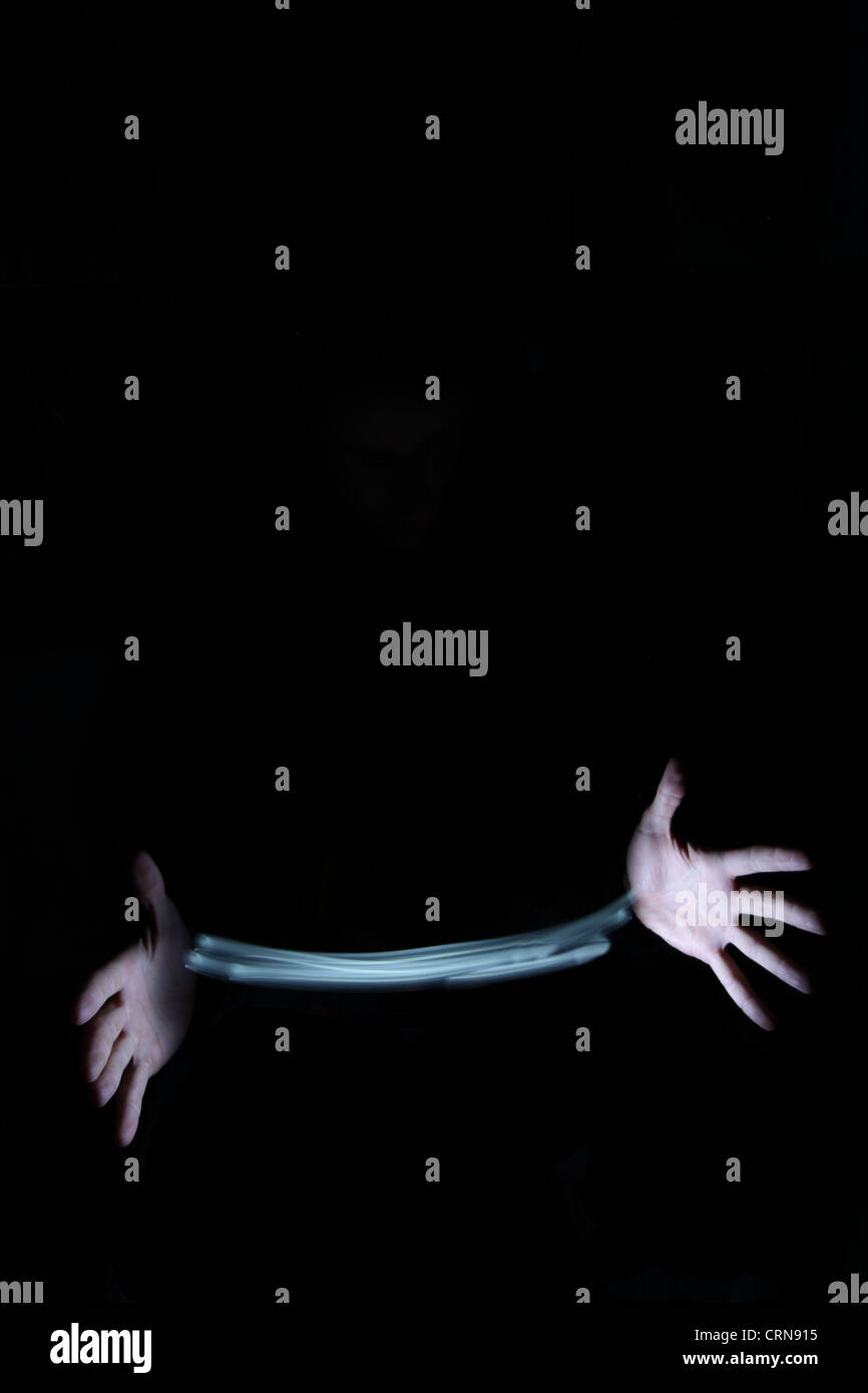 Hands of a magician producing and mastering light Stock Photo - Alamy