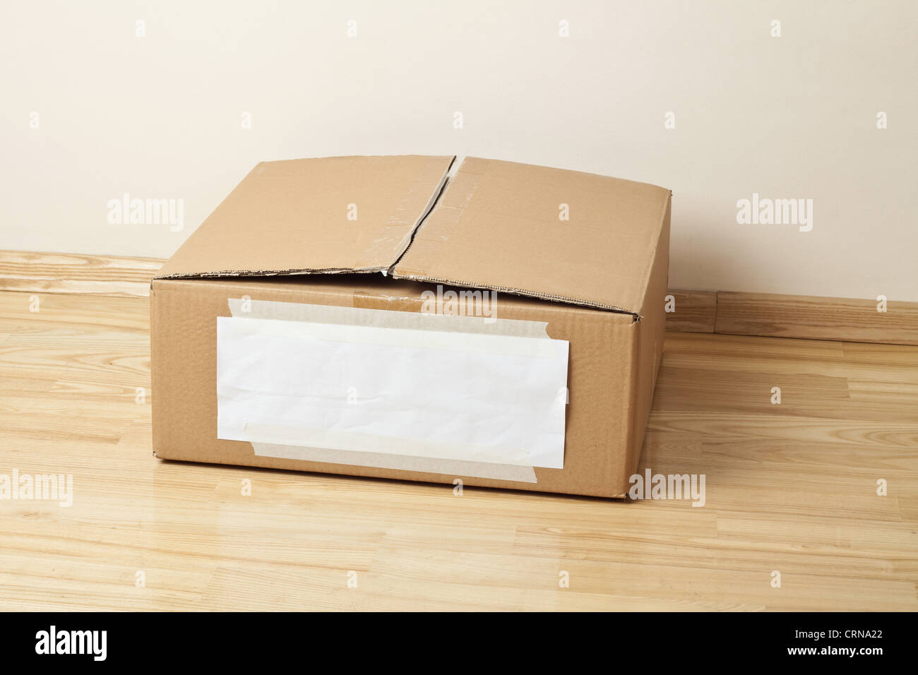 Cardboard box with blank label. Moving, storage concept. Stock Photo