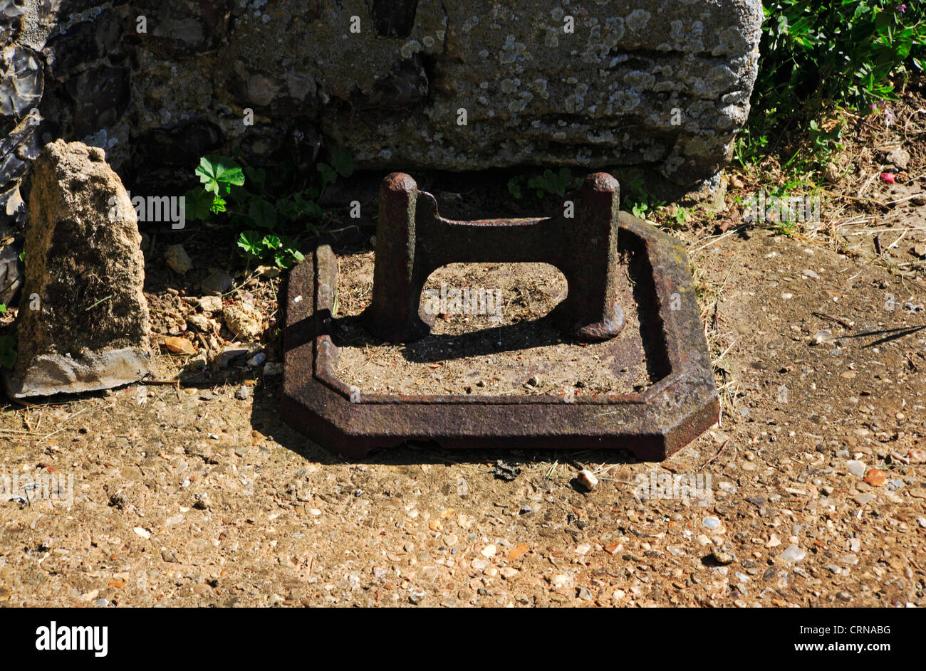 A view of a mud scraper by the south porch of the Church of St Martin at New Buckenham, Norfolk, England, United Kingdom. Stock Photo