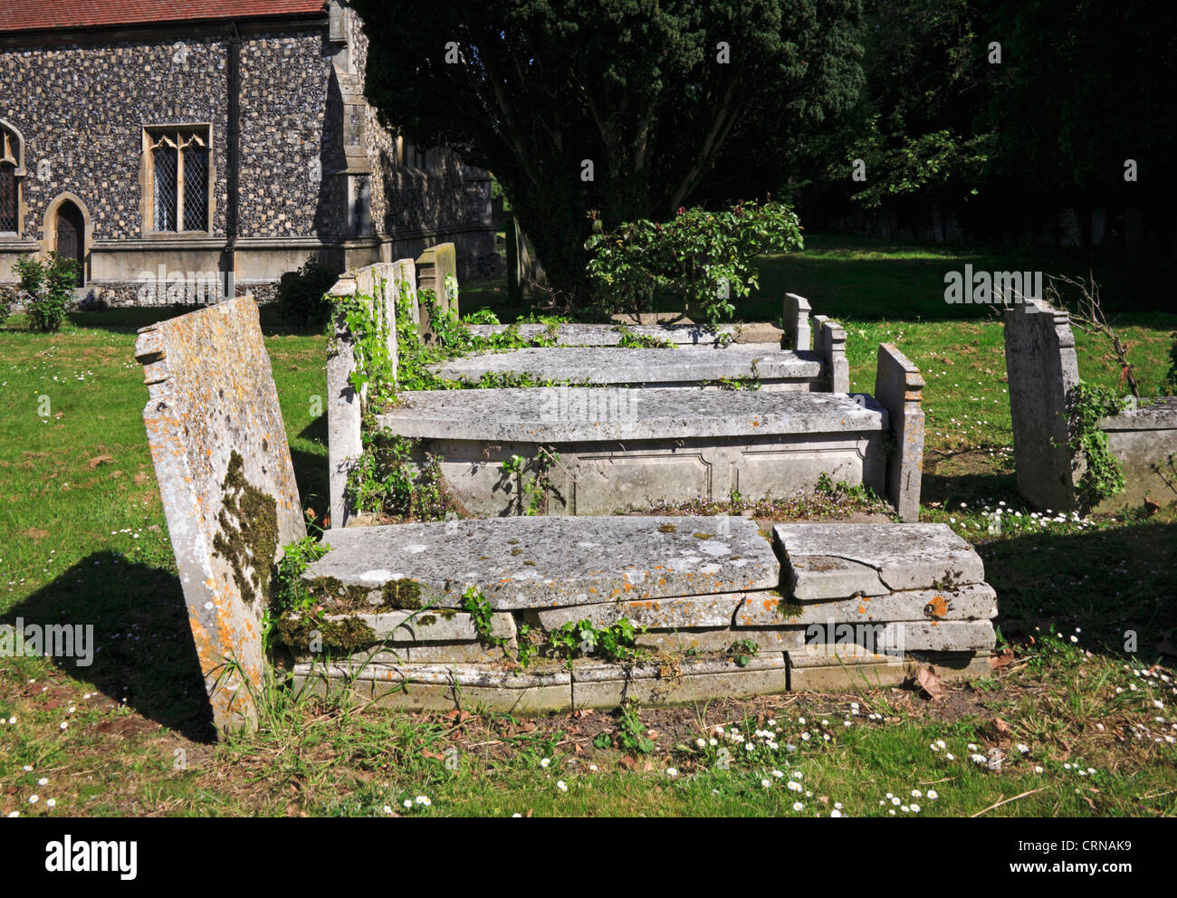 A row of old tombs in the churchyard at New Buckenham, Norfolk, England, United Kingdom. Stock Photo