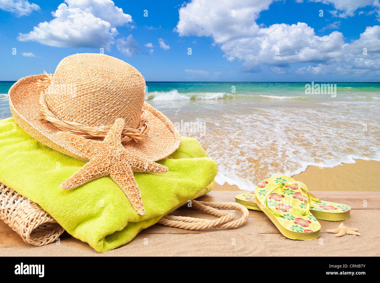 Beach bag with towel and sun hat overlooking the ocean Stock Photo
