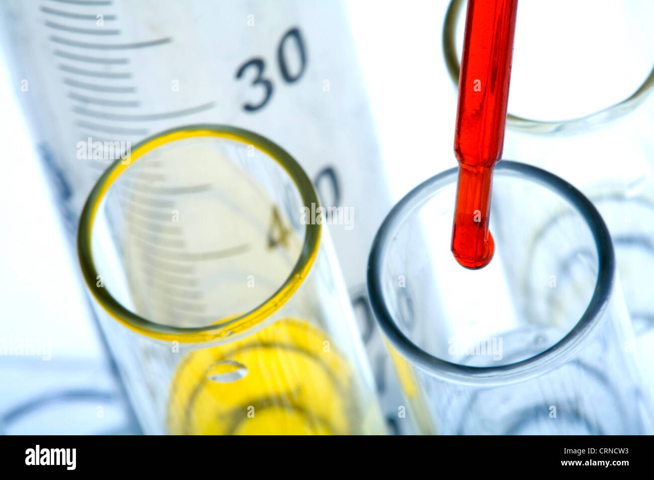 Pipetting red liquid into test tubes Stock Photo - Alamy