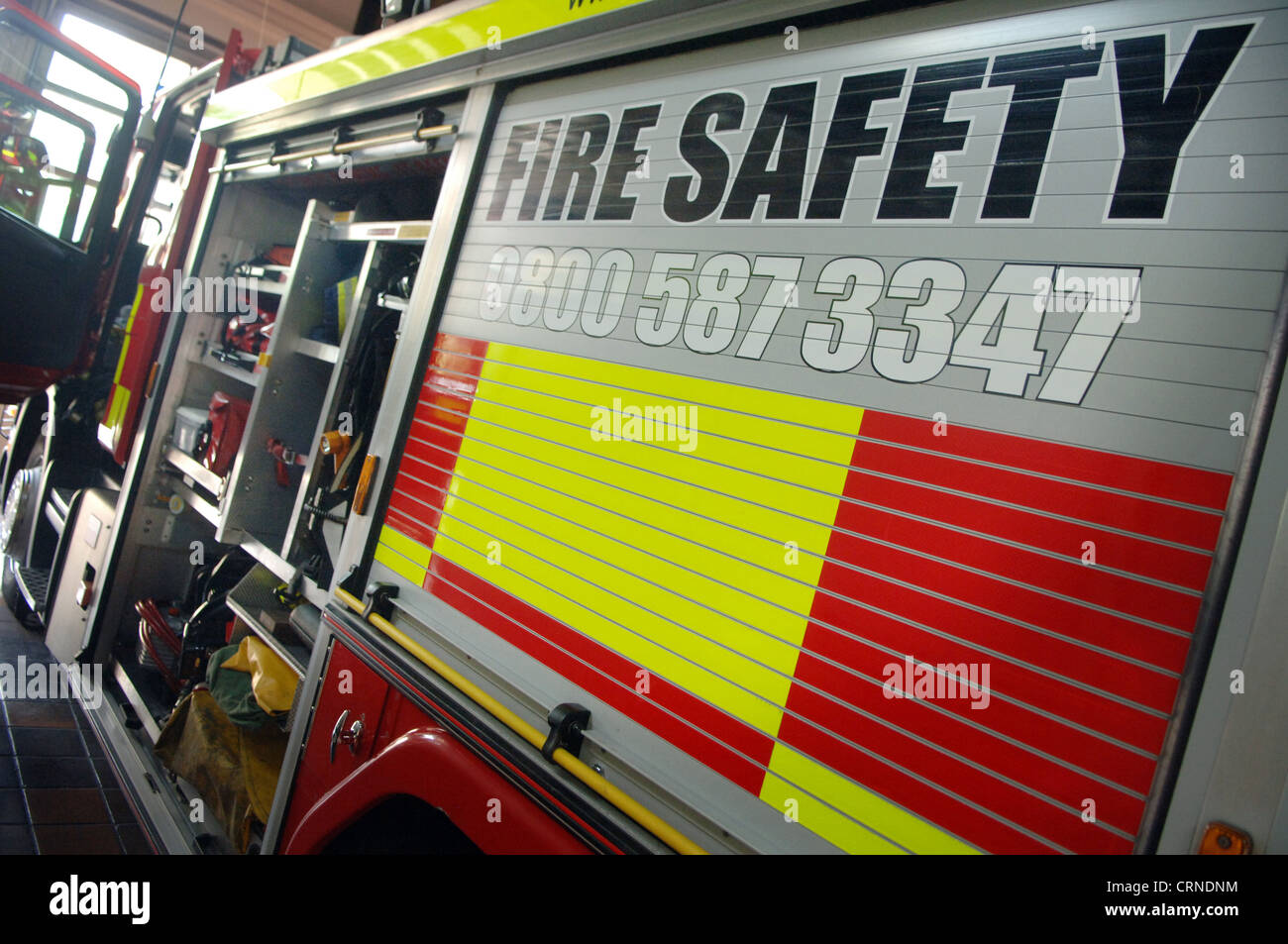 fire truck in the station with doors open and equipment showing Stock Photo