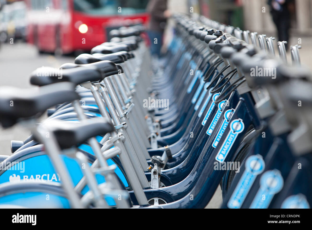A row of Barclays Cycle hire scheme bikes in a docking station. Stock Photo