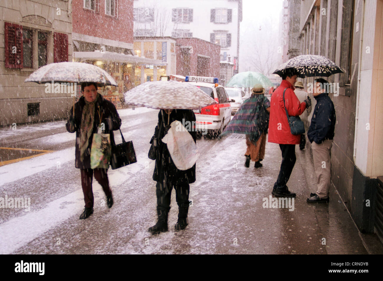 People with umbrellas in snow Stock Photo Alamy