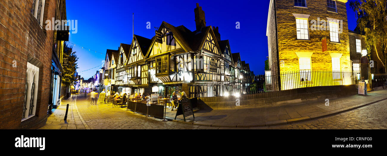 A panoramic view of people eating and drinking outside the Old Weavers House on the High Street in Canterbury. Stock Photo