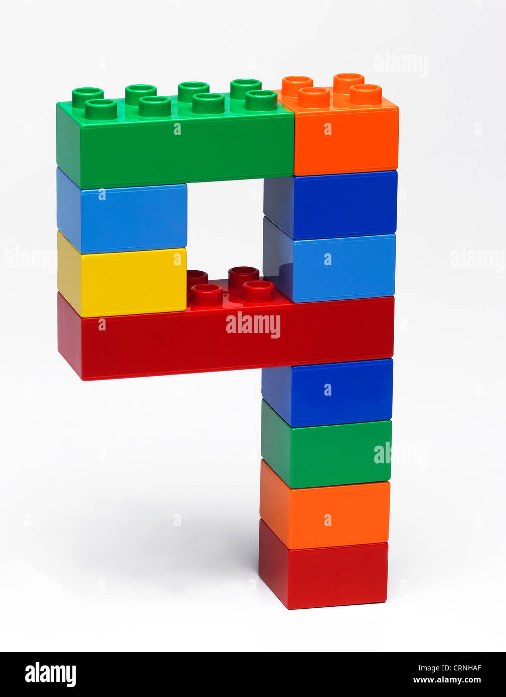 Coloured plastic building bricks in the shape of the number 9 Stock Photo