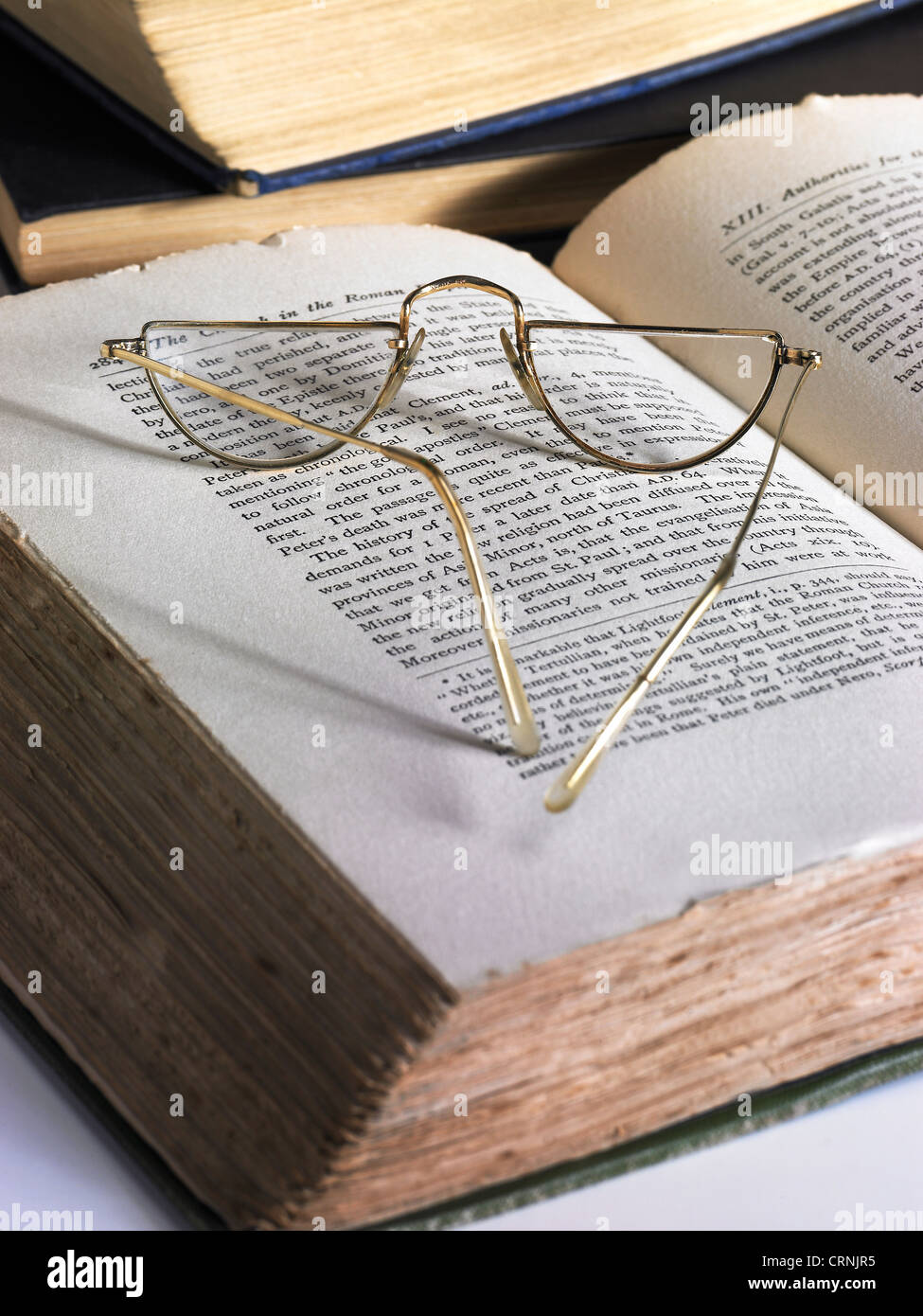 An open book and a pair of reading glasses Stock Photo