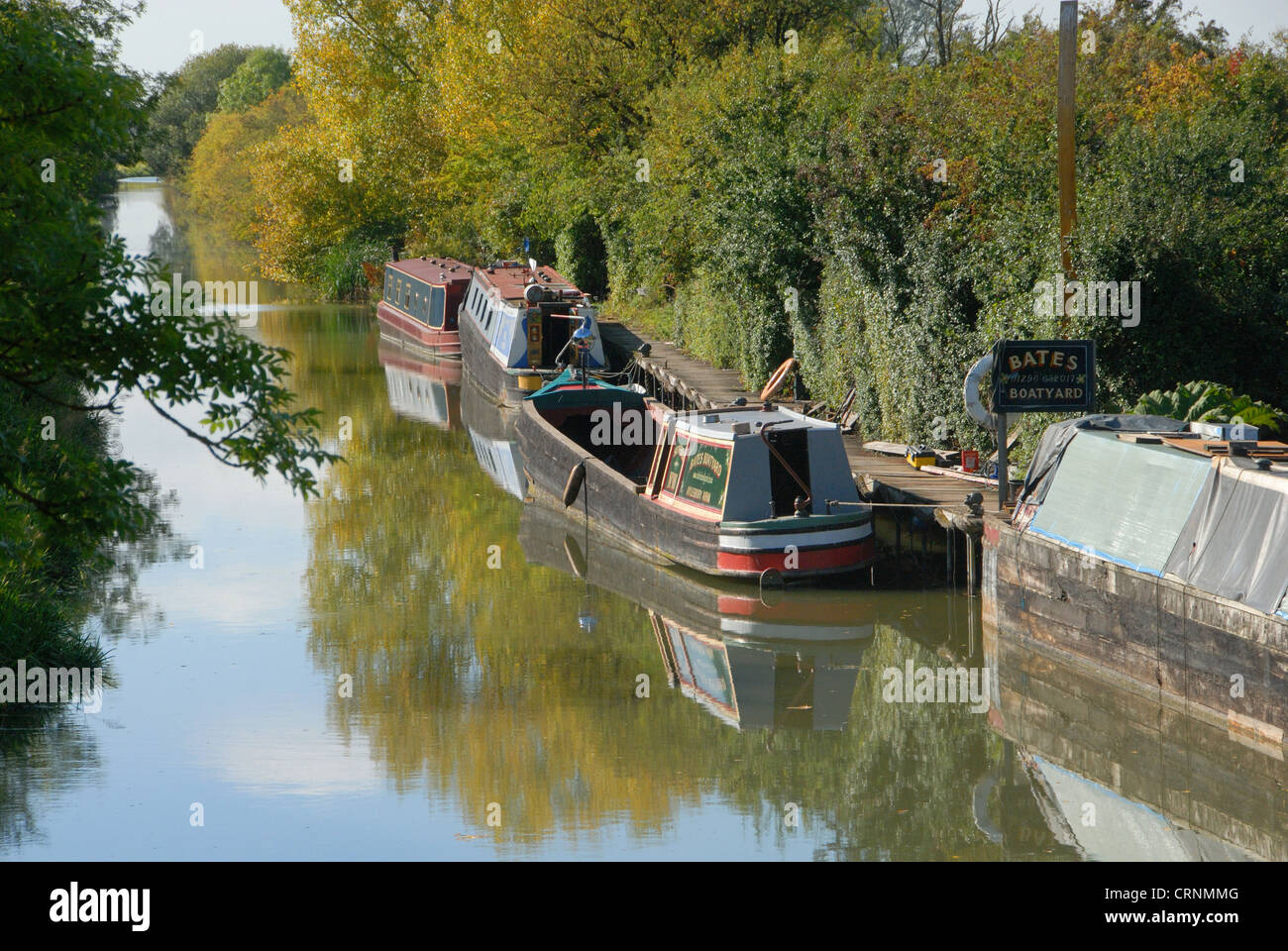 Narrowboats moored at boatyard on canal, Aylesbury Arm, Grand Union Canal, near Puttenham, Hertfordshire, England, september Stock Photo
