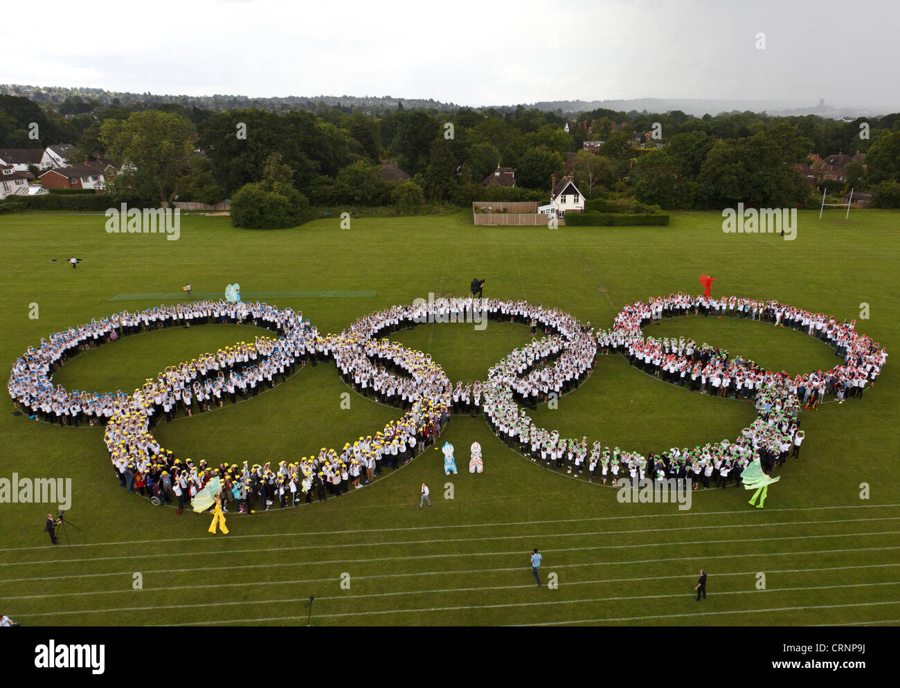 Elevated view of world record to form the largest human Olympic Rings symbol, comprising 1,900 school children and staff at Geor Stock Photo