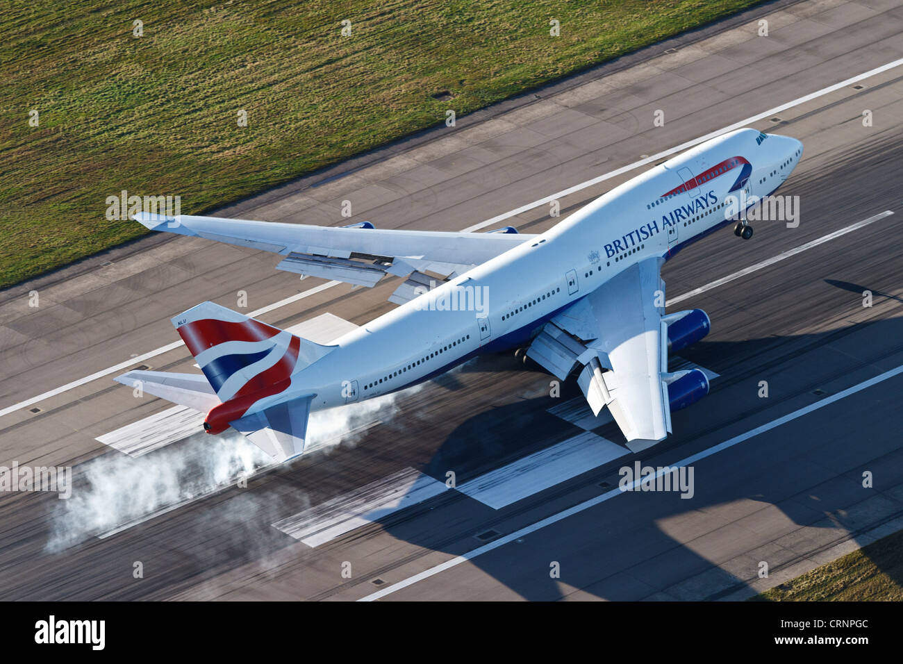 Aerial view of a British Airways Boeing 747 landing on Runway 27R at London Heathrow Airport. Stock Photo