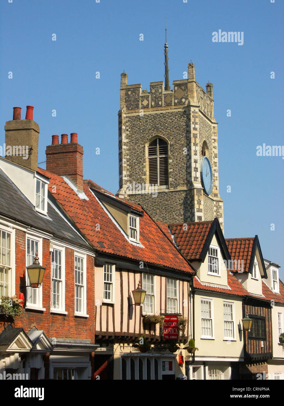 The tower of St George's church behind Georgian buildings on Princes Street in the Tombland area of Norwich. Stock Photo