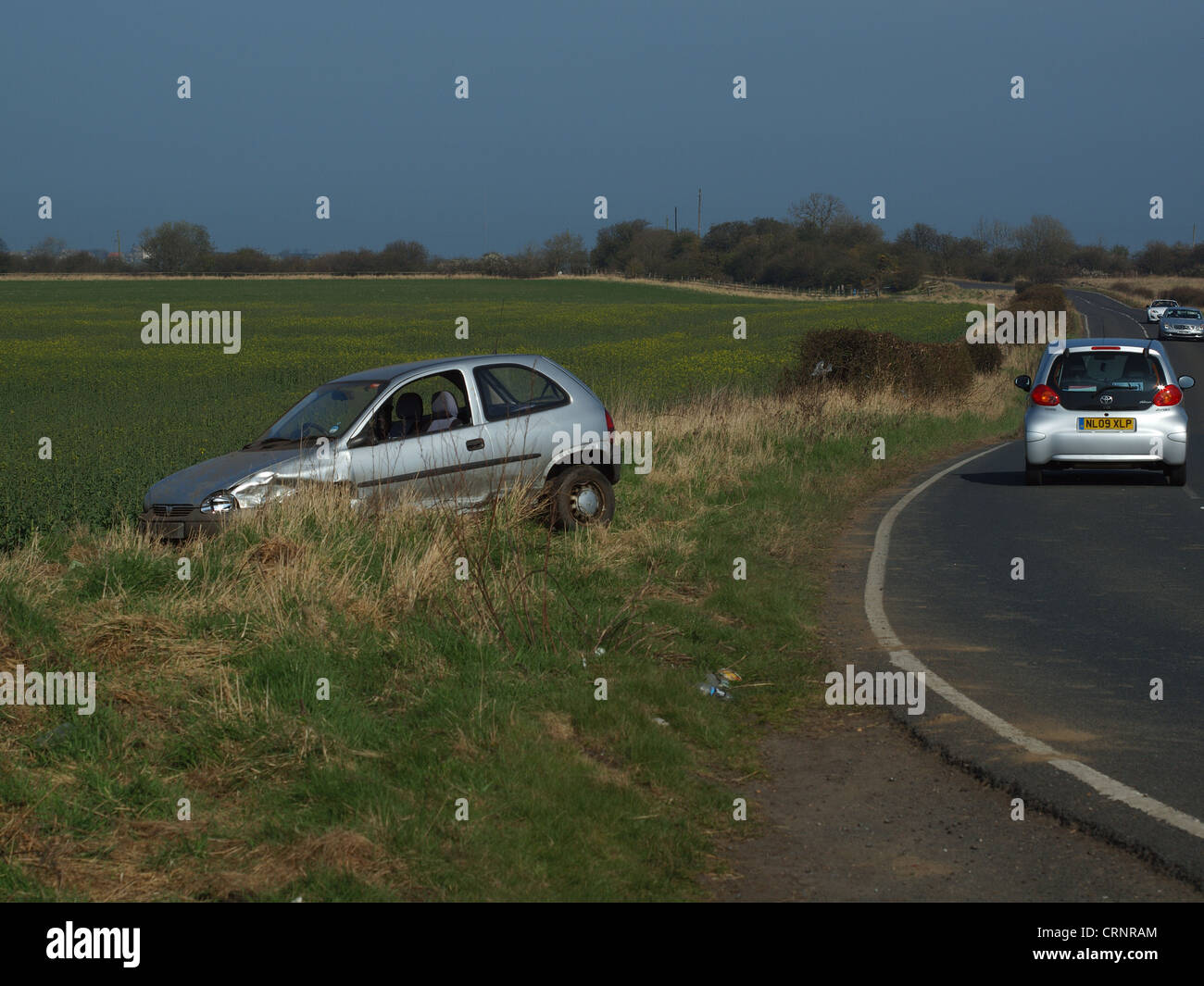 A road vehicle which failed to negotiate a bend in the road, resulting in a car accident upon the roadway. Stock Photo