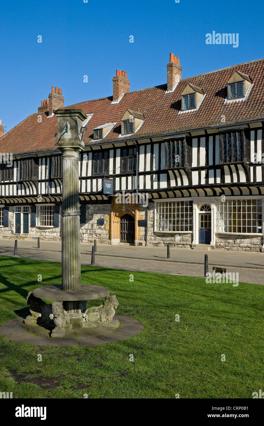 Sundial outside St William's College. The building dates back to the 15th century and was established under a license granted by Stock Photo