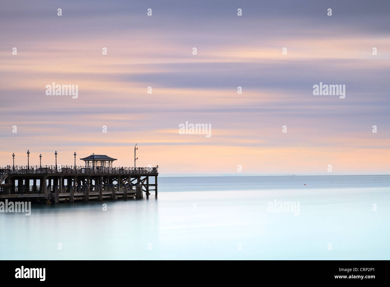 The Victorian pier at Swanage, jutting out into the sea, in early morning light. Stock Photo