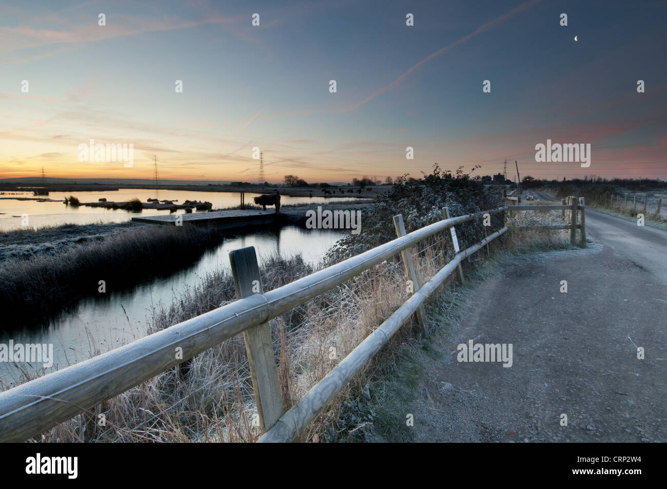 View of flooded wetland habitat and pull-in viewing point at sunrise, East Flood, Oare Marshes Nature Reserve, Kent Wildlife Stock Photo