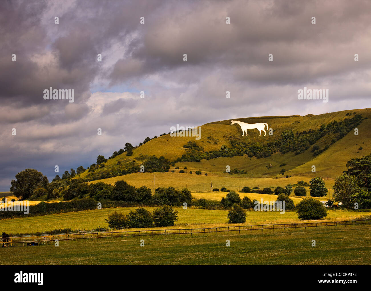 Stormy sky over the Westbury white horse, the oldest of Wiltshire's white horses, on the edge of the Bratton Downs. Stock Photo