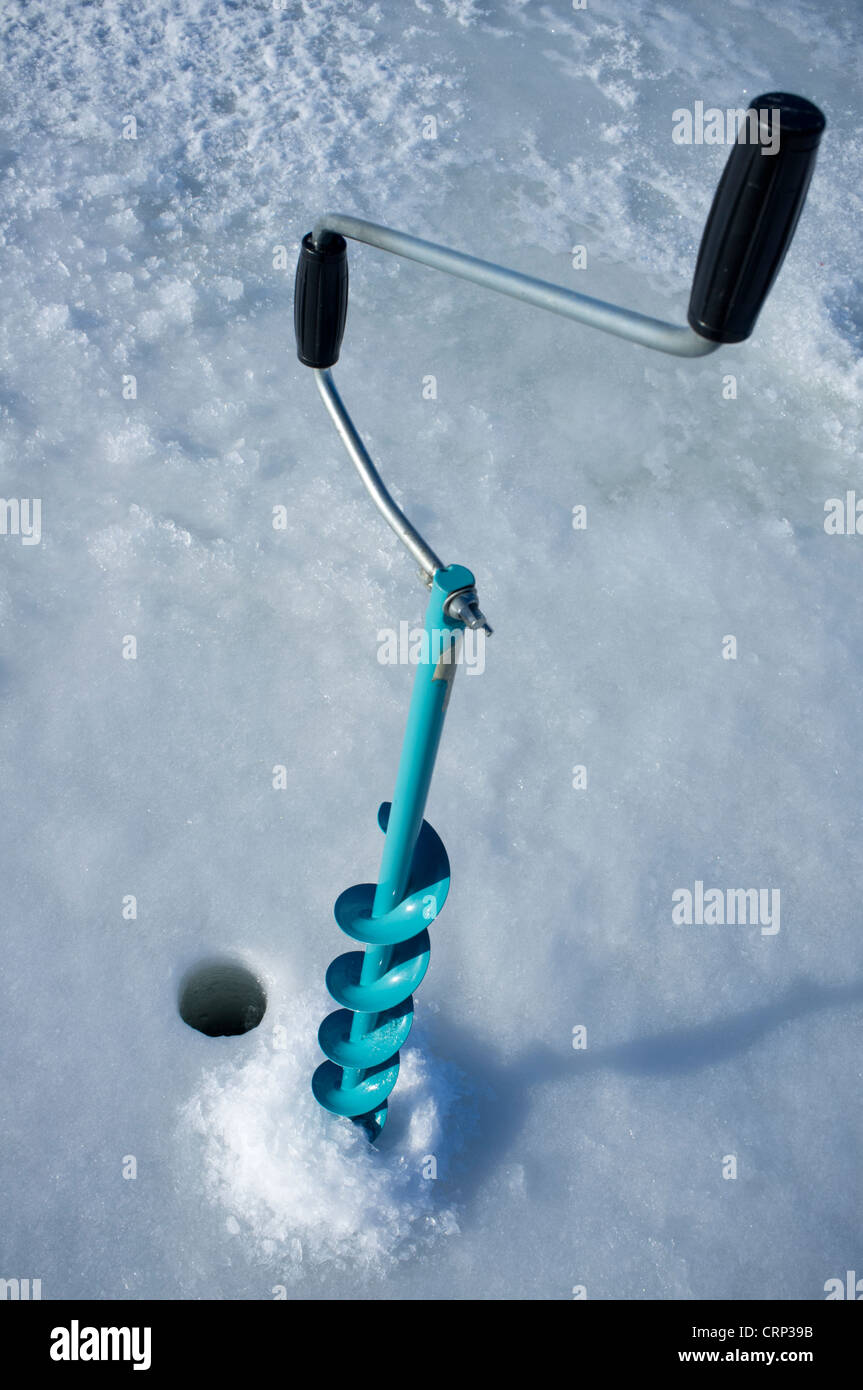 Isolated hand ice auger and tip-up ice fishing rod , Finland Stock