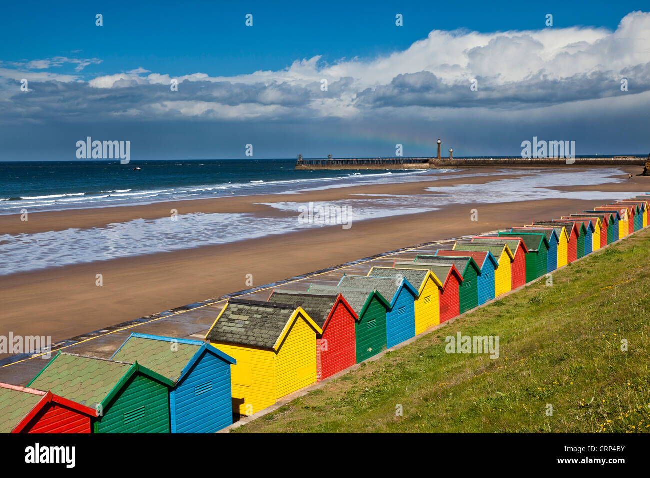 Colourful beach huts along West Cliff Beach in Whitby. Stock Photo