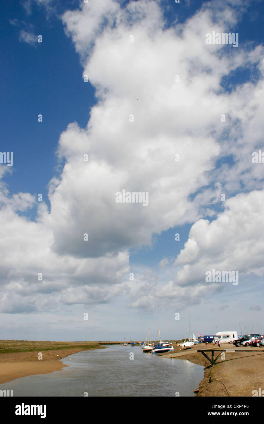 White clouds blue sky low tide Blakeney Norfolk England UK Stock Photo