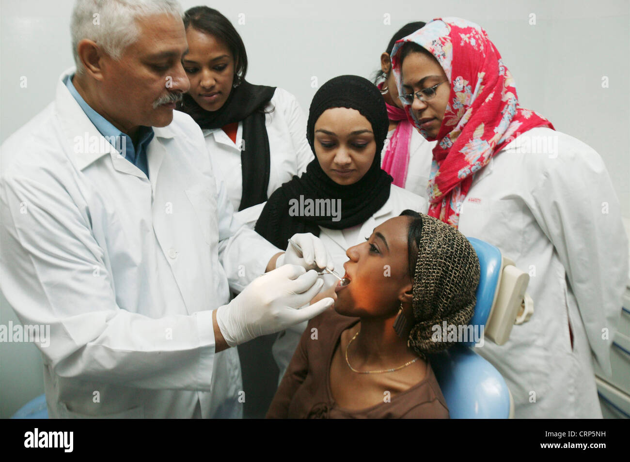 Dental students are gathering around the teacher to take part in a practical lesson. Stock Photo