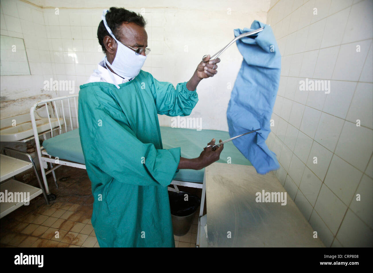 A male nurse prepares dressing table in preparation for surgical