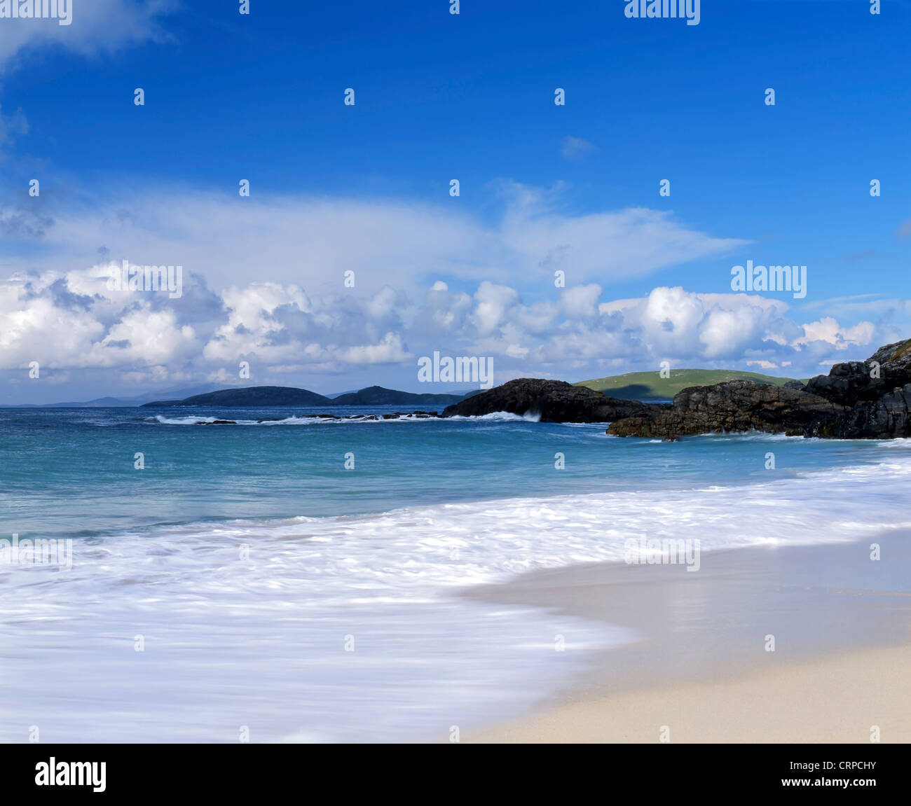Waves roll onto the sandy beach near Borgh on the tiny Hebridean island of Barra. Stock Photo