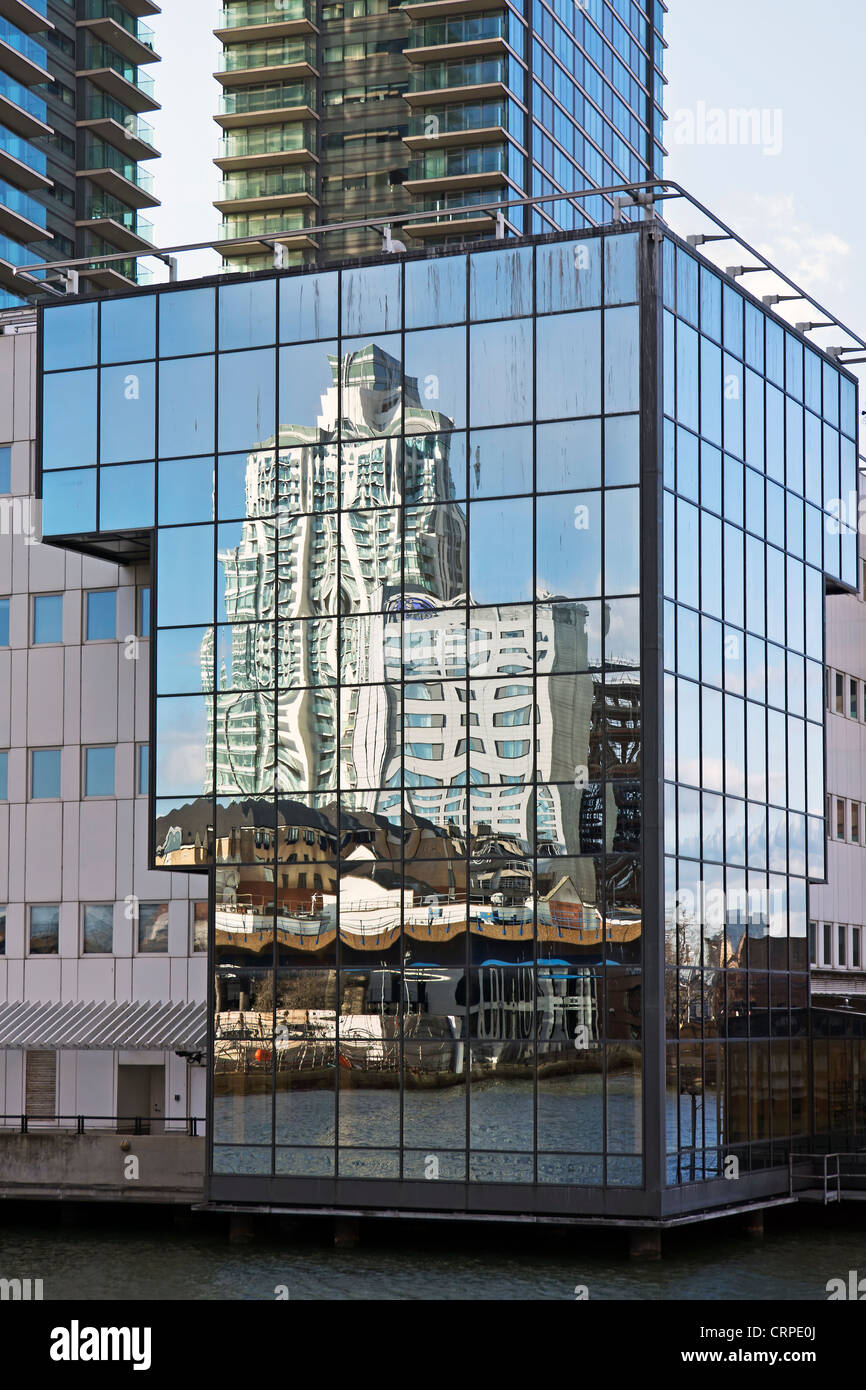 Buildings reflected in a glass clad building in Canary Wharf in the East End of London. Stock Photo