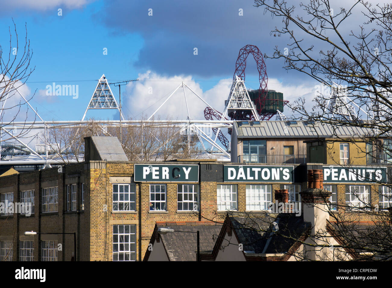 The former Percy Dalton Peanut factory with the top of the Olympic stadium and ArcelorMittal Orbit visible in the background. Stock Photo