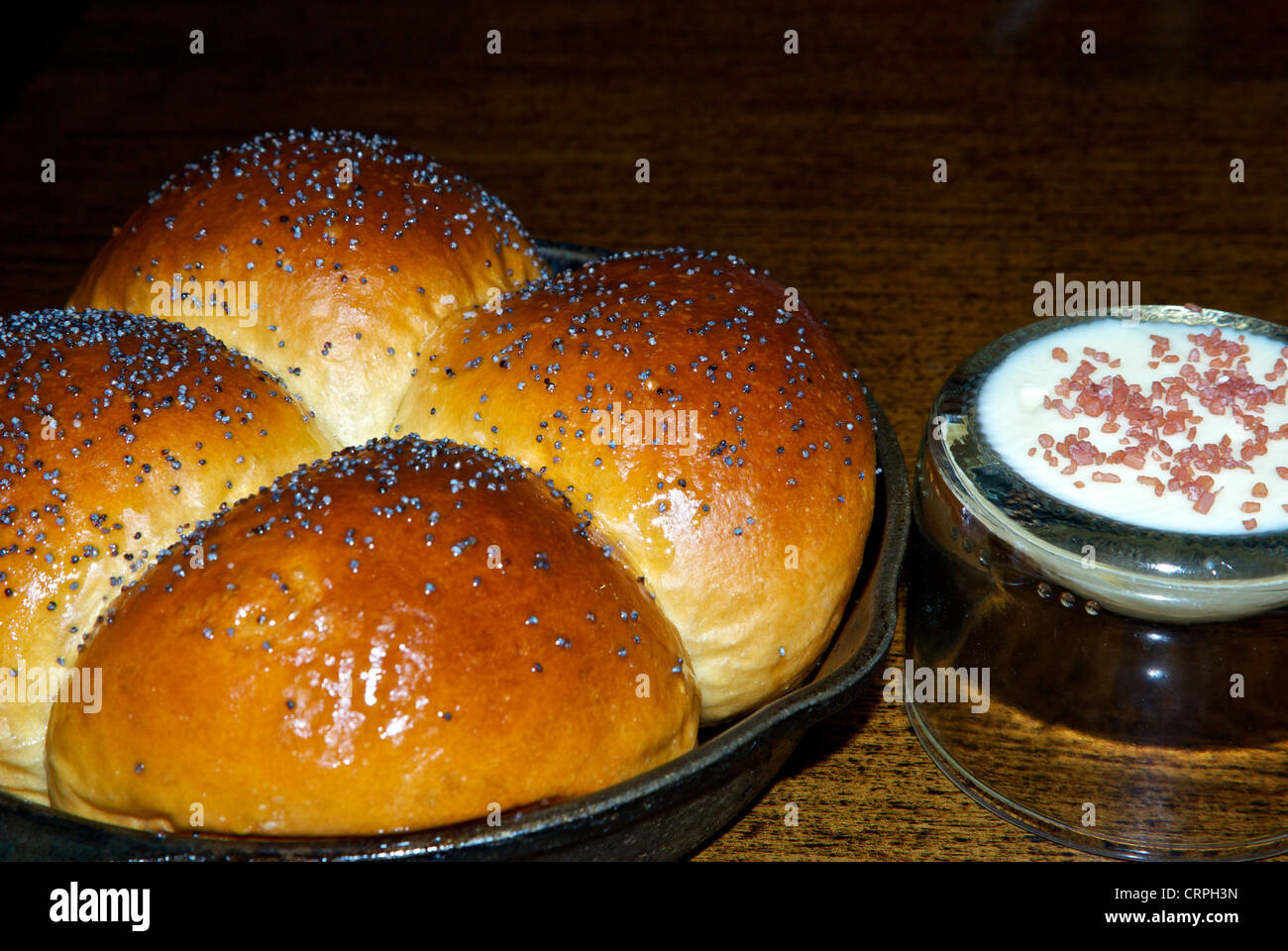 Hot poppy seed pan bread buns finely chopped Canadian back bacon butter Stock Photo