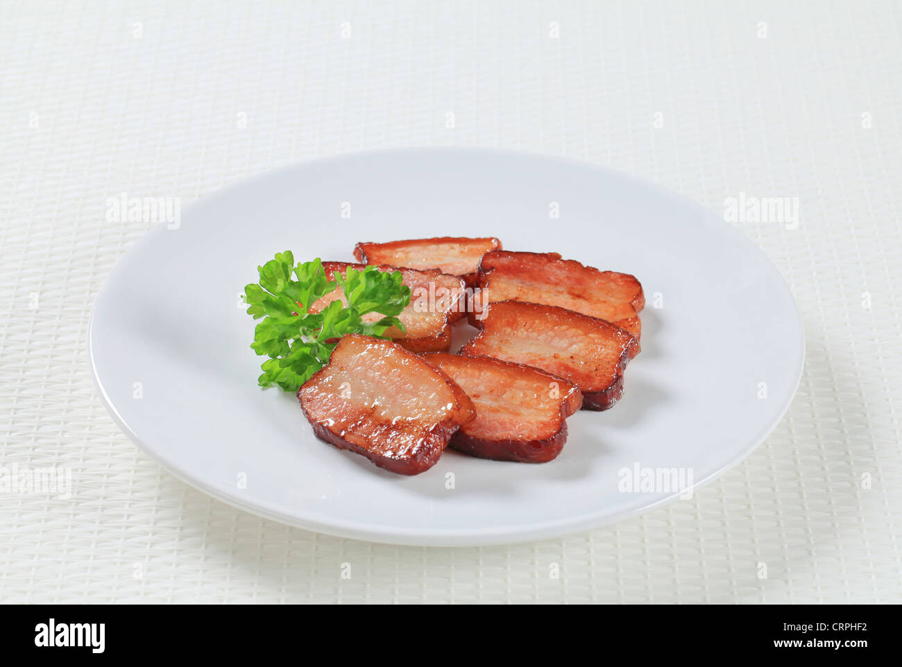 Pan fried pieces of salt pork Stock Photo - Alamy