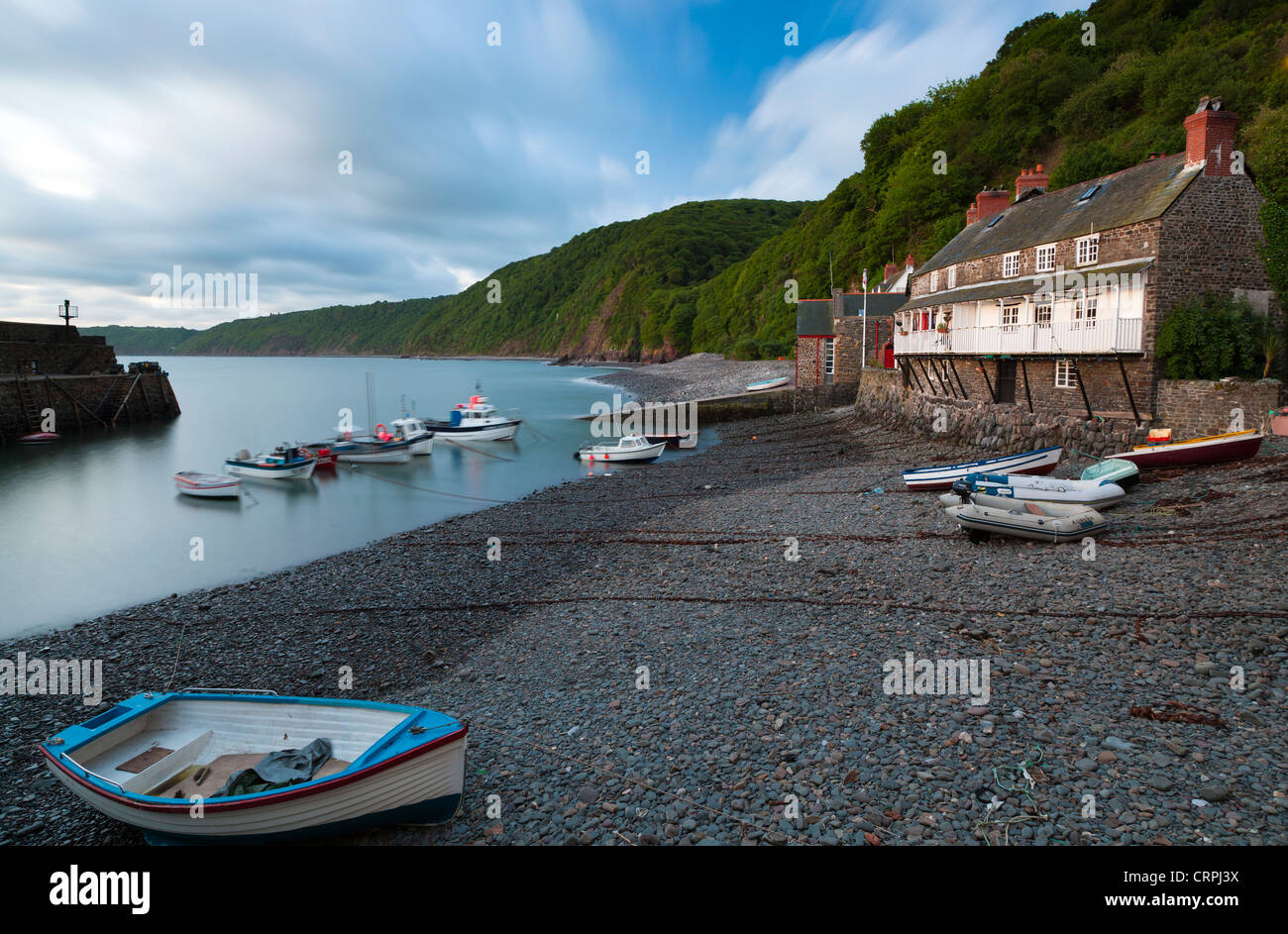Fishing boats moored in the harbour of Clovelly, a world famous, privately owned fishing village in North Devon. Stock Photo